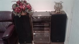 stereo/record player in glass case with 2 speakers