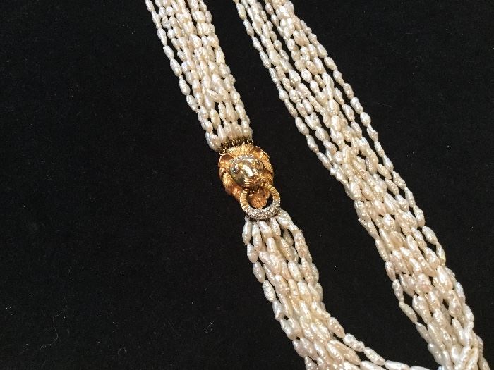 1970's gold lion's head with ring clasp an biwa pearl necklace.  Totally awesome!