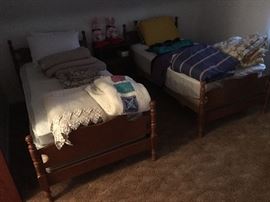 Matching Twin beds and assorted blankets, bed spreads and quilts