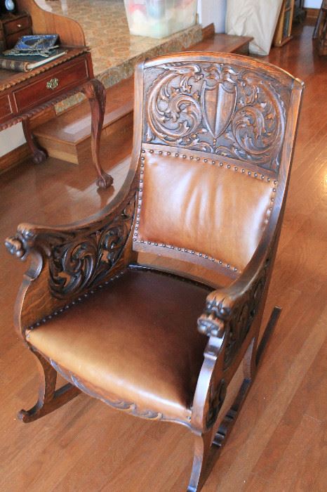 Oak and leather 19th century Scottish rocking chair. Highly carved with original finish. A beautiful piece. 