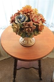 Capodimonte bouquet, placed on round walnut hall table, with cast iron and glass claw feet