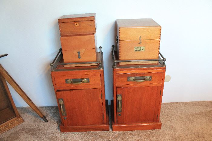 Pair of teak shipboard end tables. Authentic, not reproductions, with brass handles and finishes.  Sitting on top are various empty wooden instrument boxes or particularly nice construction.