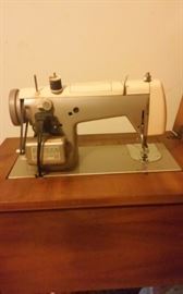 Vintage working sewing machine with a beautiful cabinet, bench and all the original documents 