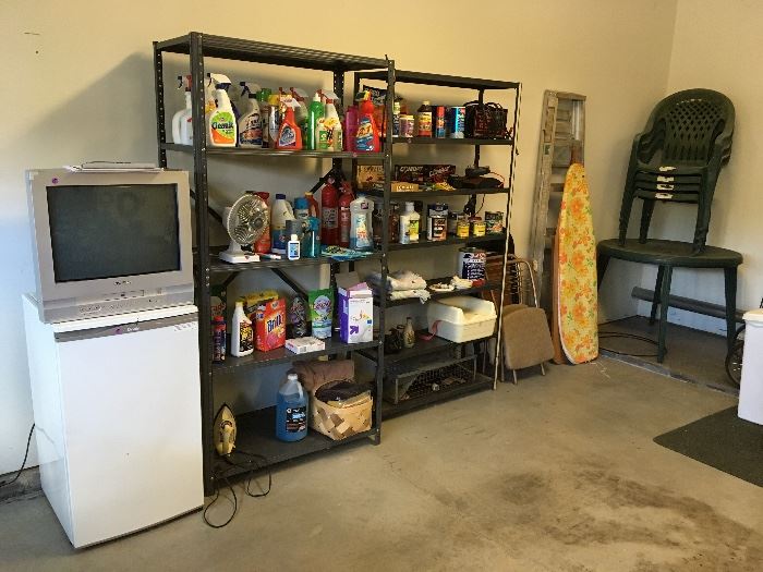 small refrigerator, TV, garage items, plastic patio set, metal shelves, aluminum step ladder