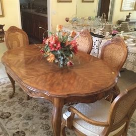 Beautiful pecan dining table. Six chairs plus one chair cushion. Also includes table pads for protection
