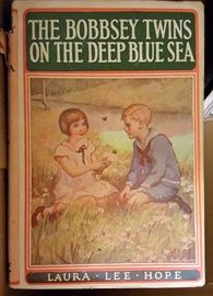 Set of Bobbsey Twins books with paper sleeves still on the books.