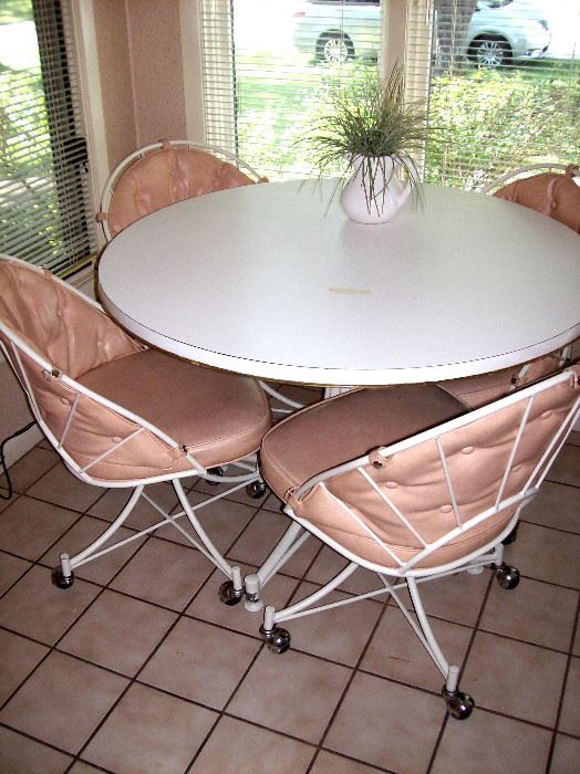   Round formica kitchen table & four chairs on casters