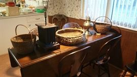 Drop down harvest type table, six matching Pennsylvania plank chairs. primitive baskets