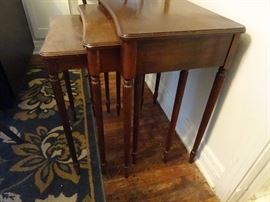 3 nesting tables in walnut with reeded legs.