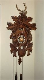 CARVED BLACK FOREST HUNTERS CUCKOO CLOCK WITH DANCERS. SWISS MOVEMENT, THIS IS A VERY HANDSOME CLOCK !