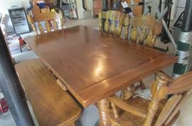 Solid, heavy duty table, four chairs and bench.  There are also two leaves than extend the length.  