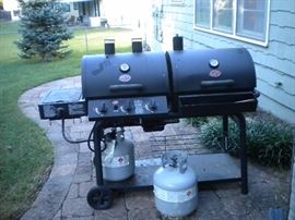Gas and charcoal gril with two propane tanks