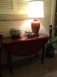 Drop leaf table; orange ginger jar lamp