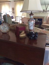 Drop leaf table and Asian plate and lamp