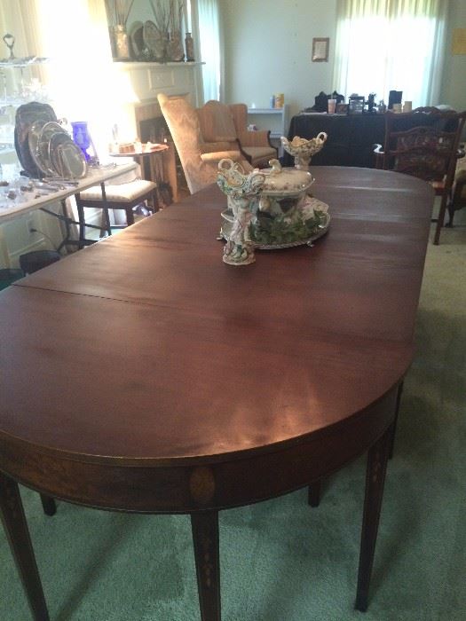 With extra leaves, this lovely dining table accommodates 16.