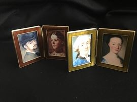 Traveling picture frames by Jay Strongwater.   They are 2.25" tall and each have decor on the front as shown in the next photograph.