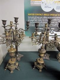 Several ornate pairs of candelabra