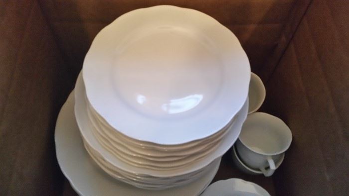 8 place settings of white dishes.