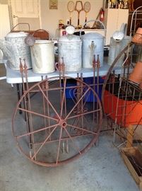2 old wagon wheels, many old watering cans