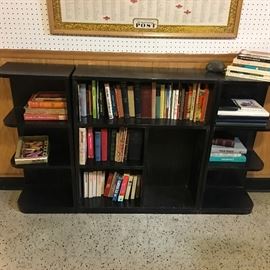 Three piece bookshelf with more books.