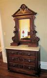 Wonderful walnut Eastlake dresser with marble top; Approximately 7 feet tall, 42" wide.