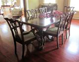 Beautiful antique reproduction Chippendale dining table, shown in this photo with 6 chairs, has a total of 10 chairs. The table has two 24" leaves for a total maximum length of 120". With no leaves, the table has a length of 72". The table width is 42".
