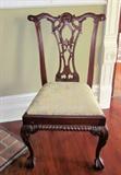 One of 10 Chippendale dining chairs.