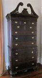 Massive and striking reproduction Chinese Chippendale two-piece chest-on-chest; Eleven drawers; Pull-out brushing slide; Approximately 7 feet tall, 37" wide.