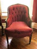 Second of two French, upholstered arm chairs; heavily carved arms and back.