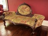 Striking antique Victorian cameo-backed settee or chaise lounge. Heavy ornate carving and beautiful fabric. Approximately 6 feet long.