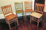 Four antique oak side chairs. One has had the seat stripped, and one has been painted green.