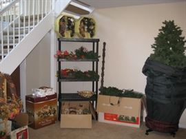 Very large lighted Christmas tree standing and one in the box.  Plus nativity set in box and wreaths