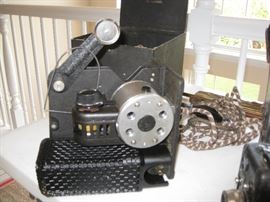 Small vintage projector with black case and cord