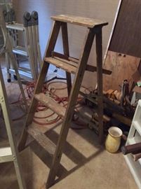 Several wooden and alum ladders