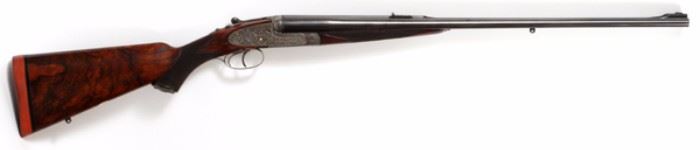 Lot#25, HOLLAND & HOLLAND, 'THE ROYAL HAMMERLESS', 375 EXPRESS, DOUBLE RIFLE, C1905, L 26" BBL, 19302.Holland & Holland "The Royal Hammerless", 375 Express double rifle. Having a fine 'Royal' scrolled engraved receiver  with gold inlay "Safe", gold inlaid pivot pin visible at the side plates. Gold oval monogrammed medallion inscribed: "EIW". Beautiful French walnut stock with cheek plate. Checkered curved wrist with engraved end plate which has a hinged access door with two spare firing pins and second front sight with hinged white dot. Engraved trigger guard and tang that has engraved serial number "19302" and extends to grip cap. Dual triggers. French walnut checkered splinter forearm. Side by side engraved barrels with ejectors, 26" L., with fixed 100 yard rear sight and fold down leaf sights stamped "200" and "300"(yards). Blued finish and engraving at the chamber with interchangeable front sights, with flip up night sights. London first and second proof marks. Smokeless powder pro