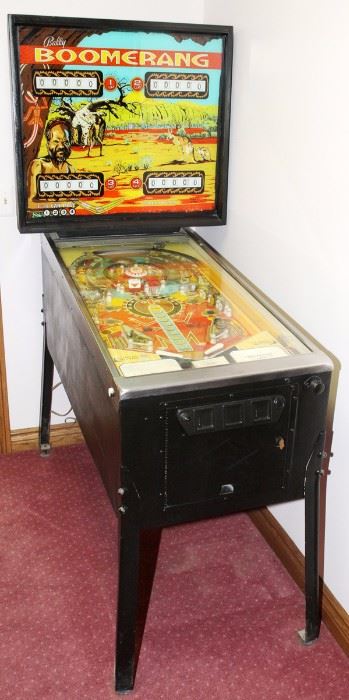 Lot#23, BALLY BOOMERANG, 25 CENT, PINBALL MACHINE, FOUR PLAYERS, H 70", W 30 1/2", D 53"Bally Boomerang four player pinball machine.  Plate inscribed: "Three balls per player, 1 play 10 cents, deposit 2 nickels, three plays 25 cents".  Oliver Vending Co. Label.