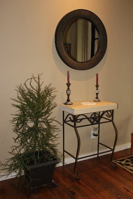 stone slab entry table, candlesticks, mirror, plant