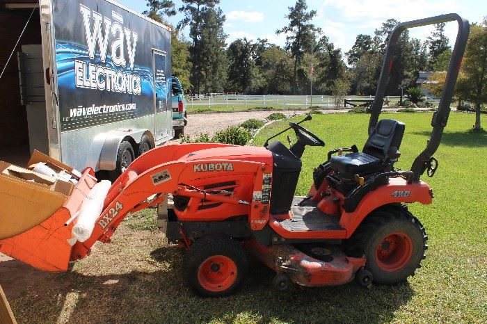 Kubota tractor with front loader and back hoe lawn mower.