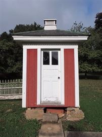 early double seat outhouse with window and vent