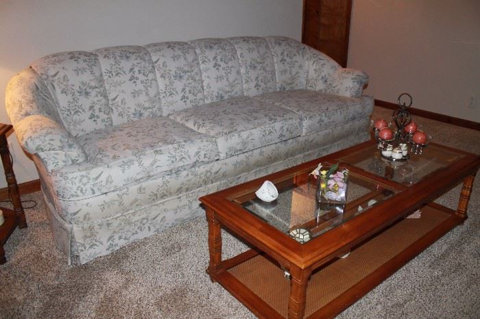 Floral sofa in excellent condition. Glass top coffee table.