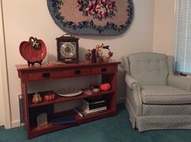 Upholstered chair.  Oak Sofa Table.   Large hooked rug. 