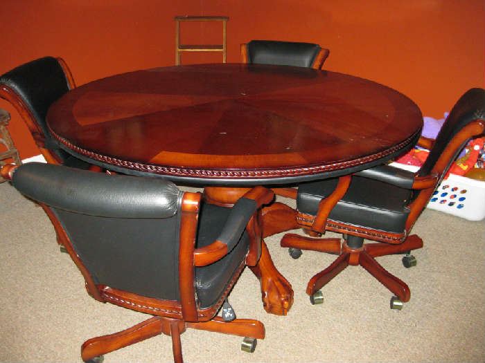nice wood game table with 4 rolling leather chairs