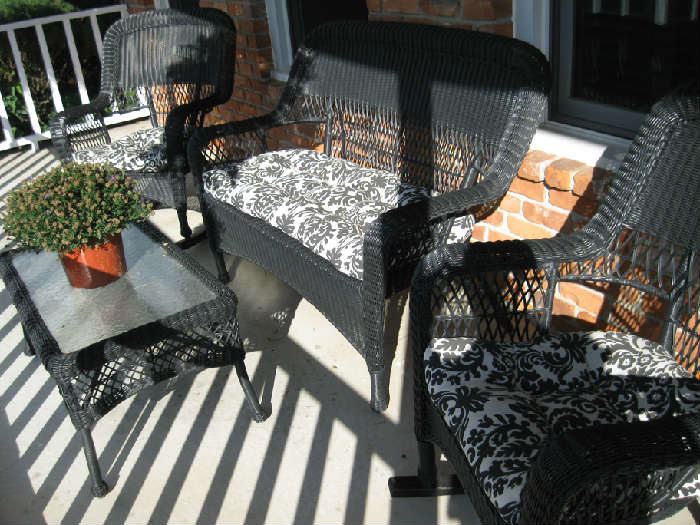 out door wicker furniture, two rockers, love seat and table.