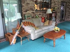 Colonial style coffee table with end tables.  Leather sofa, magazine rack, lamps.