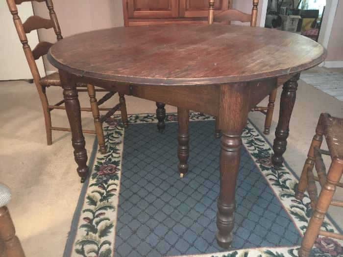 Antique oak dining table with center leg; 4 maple ladder back chairs.