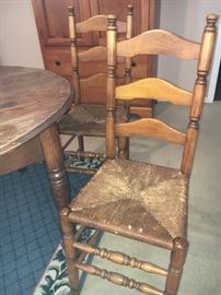 Antique oak dining table with center leg; 4 maple ladder back chairs.