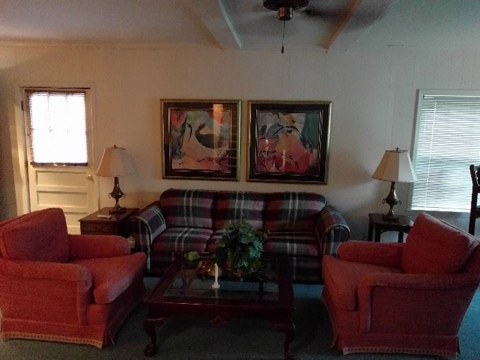 Downstairs entertaining was never so swanky as this comfy vignette! 1980's metrosexual lumberjack plaid sleeper sofa, flanked by a pair of peachy-keen upholstered armchairs. The mahogany coffee table is unmolested by errant binge drinkers, rescued toy poodles or rug rats.                                                                         It even had a beveled glass top to keep your narcissistic friends entertained during Tupperware parties.