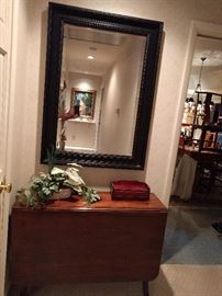 McMansion black-framed mirror, lording over a very nice 1940's mahogany drop-leaf table. The next pic shows you how nice the detail is on the side.                               NO, I'm not drunk, the house is tilted!