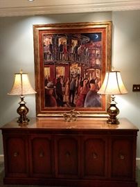 Deluxe Drexel MCM mahogany buffet, with pair of heavy brass lamps, watched over by an original oil, artist signed, of Bourbon Street, New Orleans. 