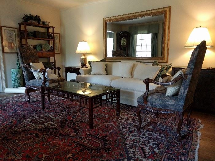 Very nice living room, with pair of Sherrill Carved French Louis XVI Style Open Arm Upholstered Chairs, gorgeous Persian Heriz, Asian wood/beveled glass coffee table, pristine Frederick Edward camel back sofa, authentic Asian etagere, Pair of vintage Asian porcelain lamps, Sherrill one-drawer end table, huge, crackle finish beveled glass mirror, celadon umbrella stand.